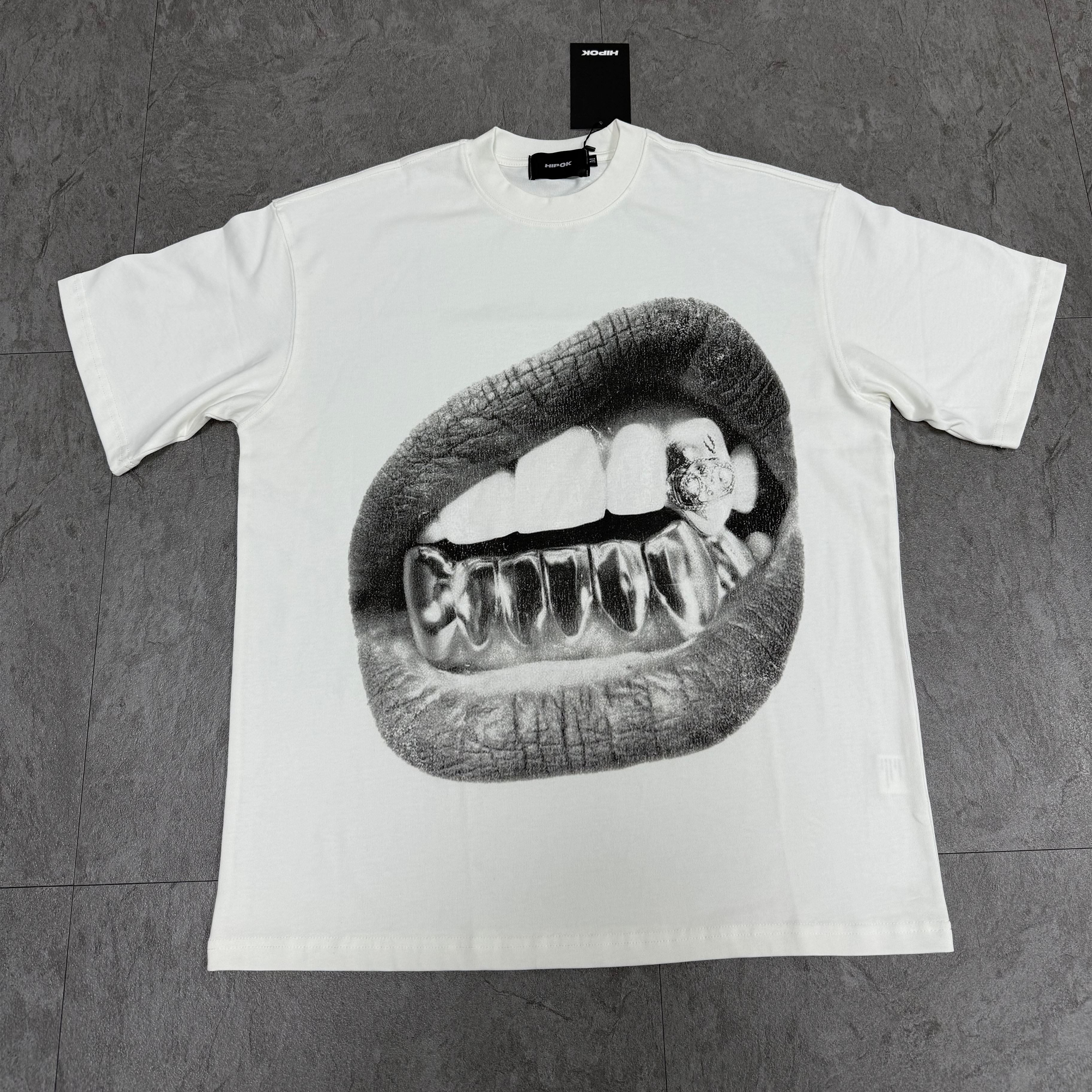 Diamond Grin white T-shirt laid flat on floor, front view